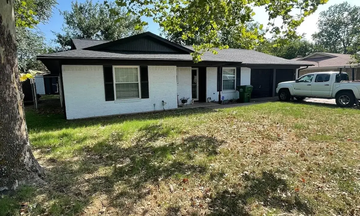 Professional roofing crew working on a residential roof in Gardner
